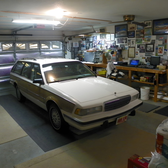 Organized Garage with Workbench, Wall Art, and Station Wagon - Mac