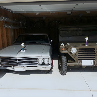 Classic Car and Military Jeep in Organized Garage - Anonymous