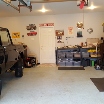 Organized garage with black SUV, cabinets, and wall art - Jerry from Hatfield, PA