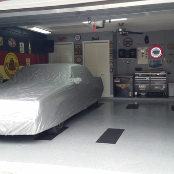 Organized garage with car cover, cabinets, and wall signs - Lewen from Kissimmee, FL