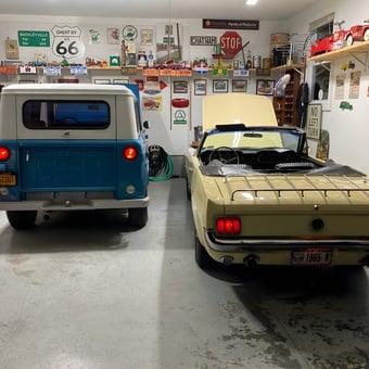 Classic Car Garage with Vintage Signs and Models - Anonymous