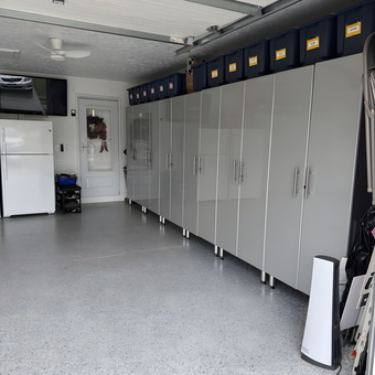 Modern garage with gray cabinets and storage bins - Lorraine