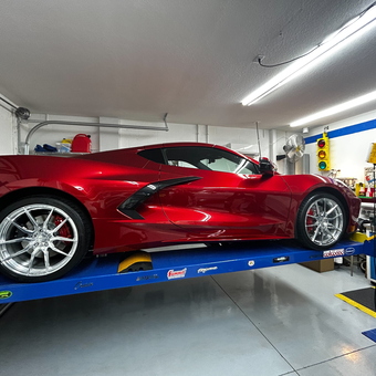 Red Sports Car on Blue Four Post Lift - White's Garage from Englewood, FL