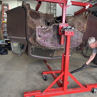 Car body on red rotisserie in garage - 1941 chivy from Watford city, ND