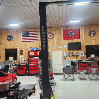 Organized garage with car lift, tool chests, and wall decor - Jeremy from CLARKSVILLE
