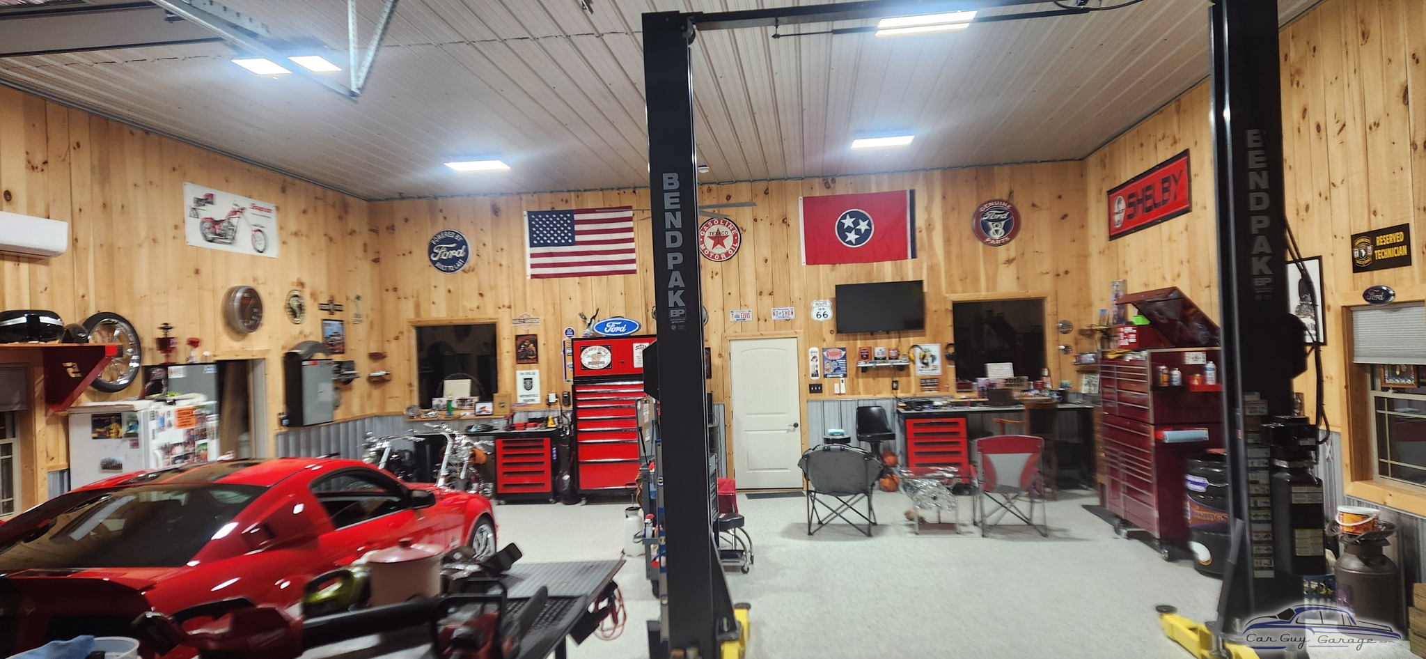 Organized garage with car lift, tool chests, and wall decor - Jeremy from CLARKSVILLE