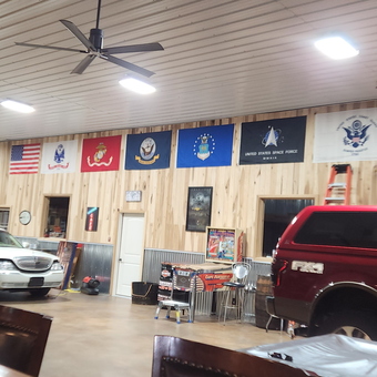 Spacious garage with vehicles, military flags, and wall decor - Jeremy from CLARKSVILLE