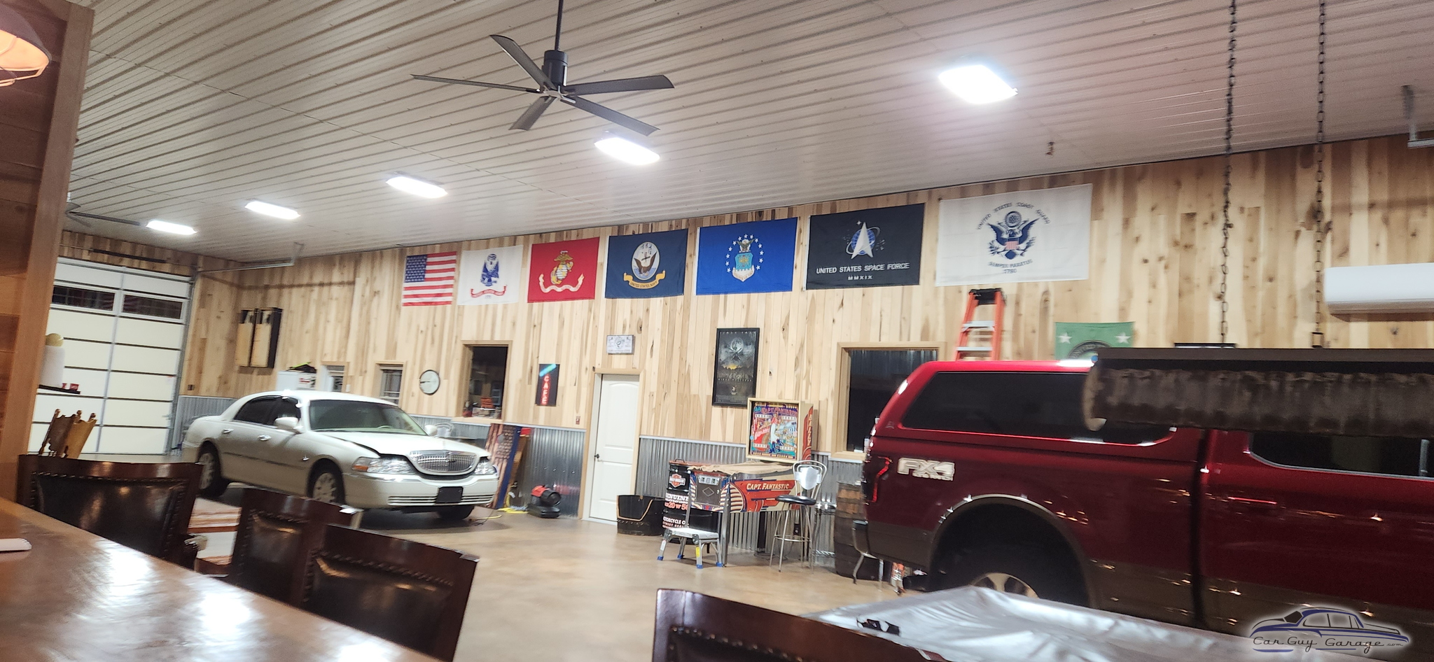 Spacious garage with vehicles, military flags, and wall decor - Jeremy from CLARKSVILLE