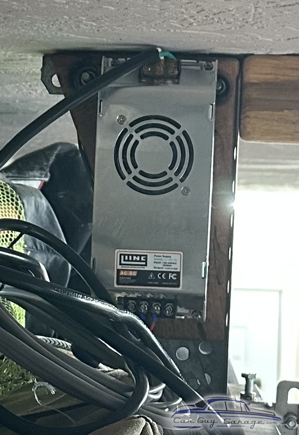 Mounted metal power supply unit with wiring in garage