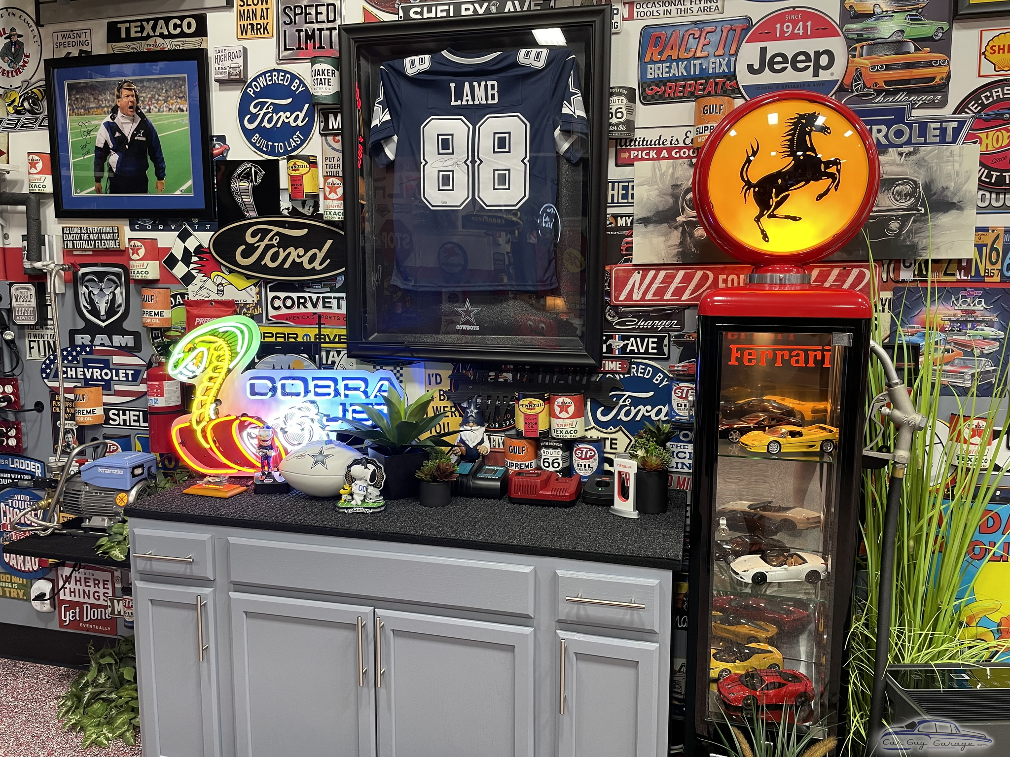 Garage Decor With Neon Signs, Ferrari Display, and Car Memorabilia