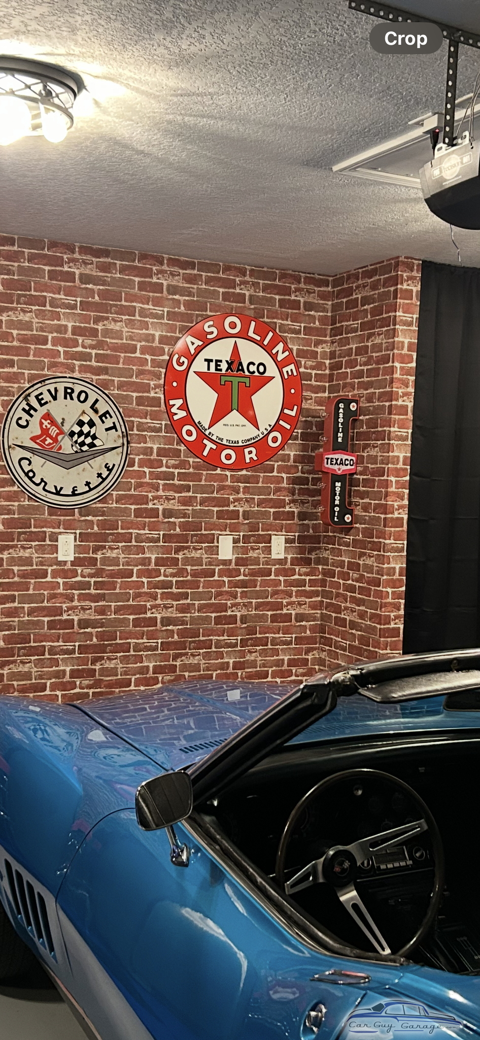 Garage With Texaco and Corvette Signs and Blue Classic Car