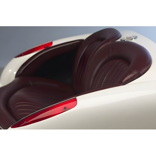 1957 Vibrant White Corvette with Bright Red Leather Couch